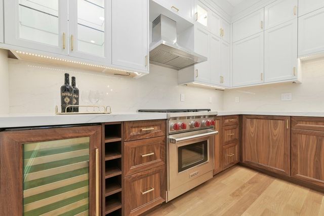 a kitchen with stainless steel appliances granite countertop a stove and a sink