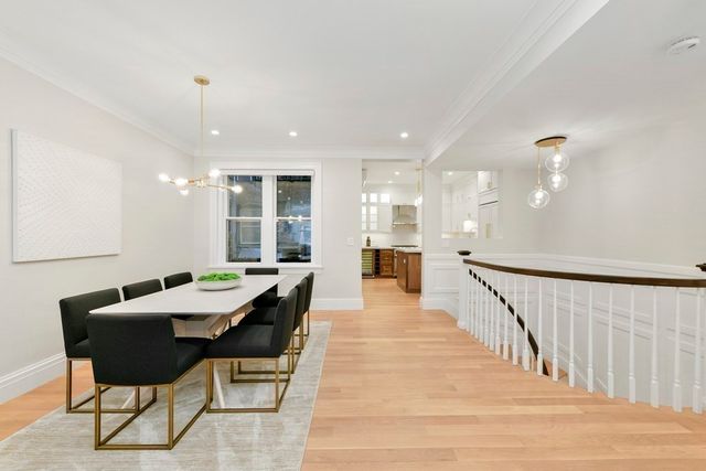 a dining room with furniture and wooden floor