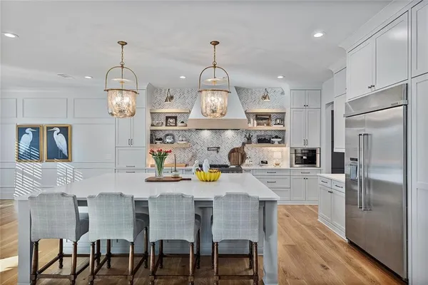 a kitchen with stainless steel appliances kitchen island granite countertop a stove and a refrigerator