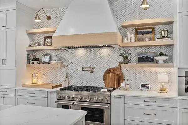a kitchen with granite countertop a refrigerator and a stove