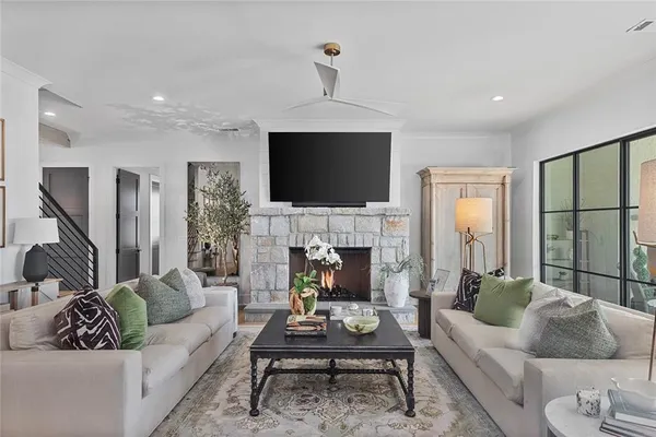 a living room with furniture a fireplace and a flat screen tv