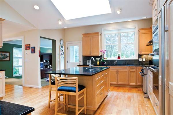 70 Clifton Road Newton, MA 02459 - Photo 6 of 13 a kitchen with stainless steel appliances granite countertop a refrigerator a sink dishwasher and a dining table with wooden floor