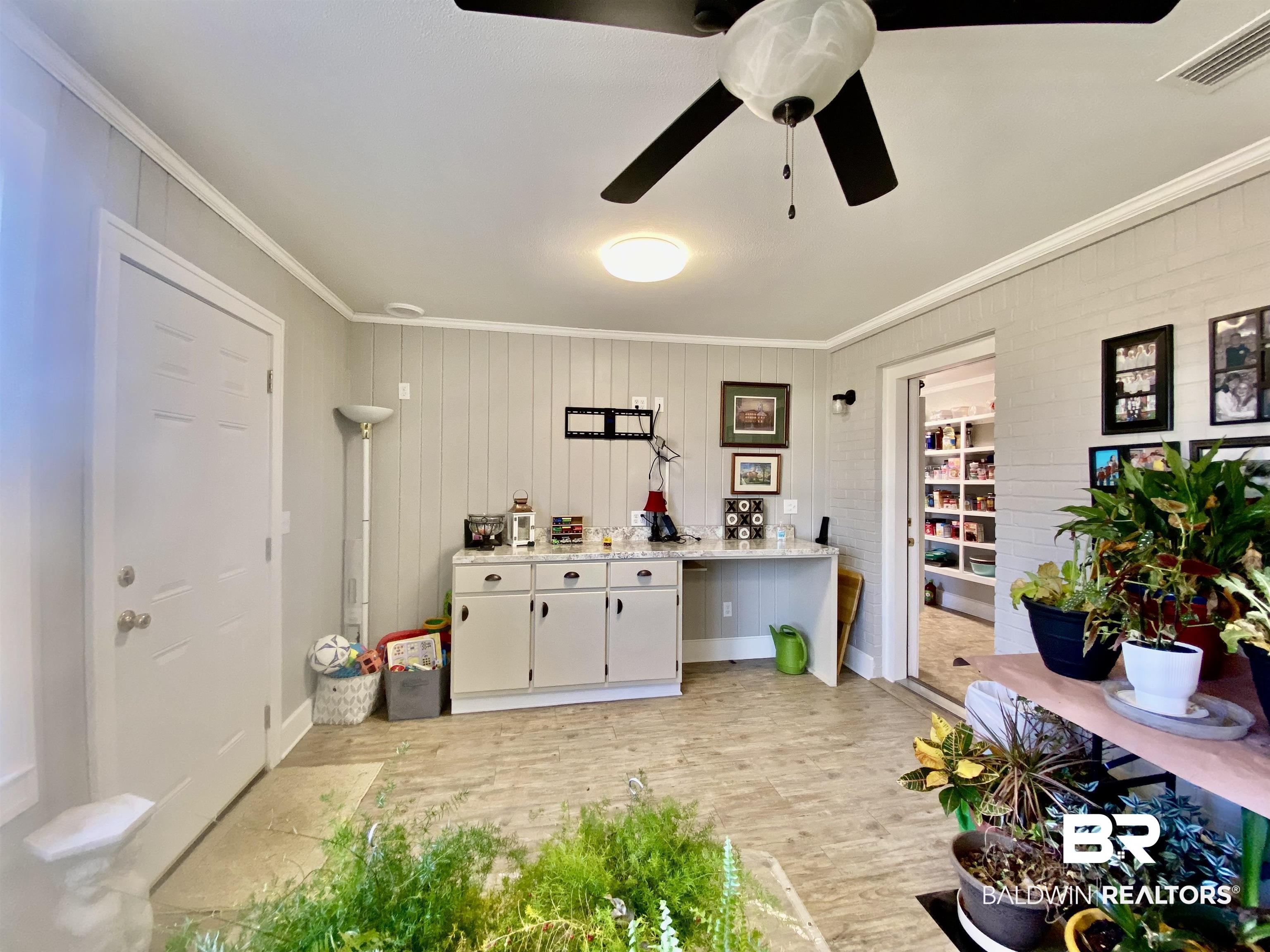 2711 County Road 5 Repton, AL 36475 - Photo 30 of 36 Sunroom with ceiling fan, crown molding, and white cabinetry