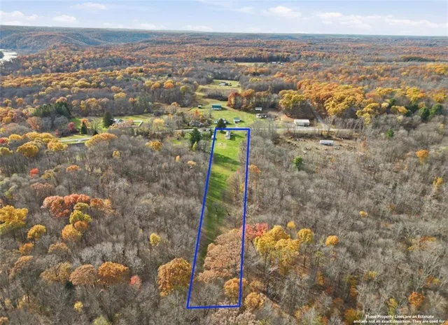 an aerial view of mountain with residential house and mountain view