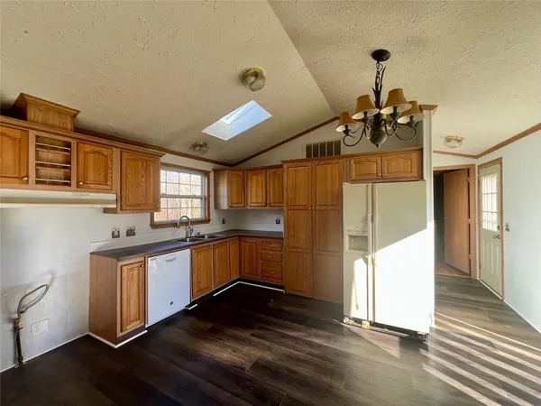 a kitchen with stove and wooden floor