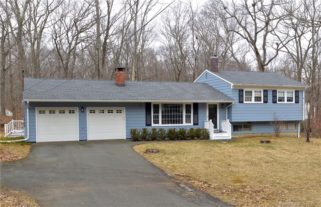 21 Summit Lane Ridgefield, CT 06877 - Photo 1 of 1 a front view of a house with a yard and garage