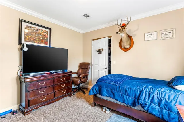 a bedroom with a bed and flat screen tv