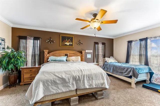 a view of kitchen island with stainless steel appliances granite countertop dining table chairs sink and wooden cabinets