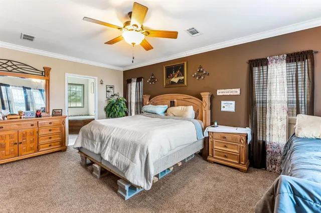 a spacious bedroom with a bed and a chandelier