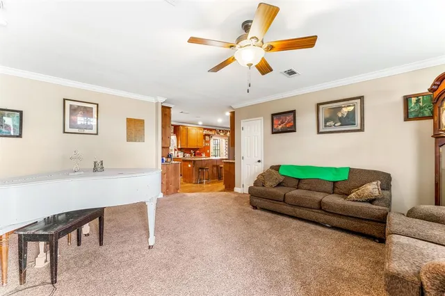 a living room with furniture and kitchen view