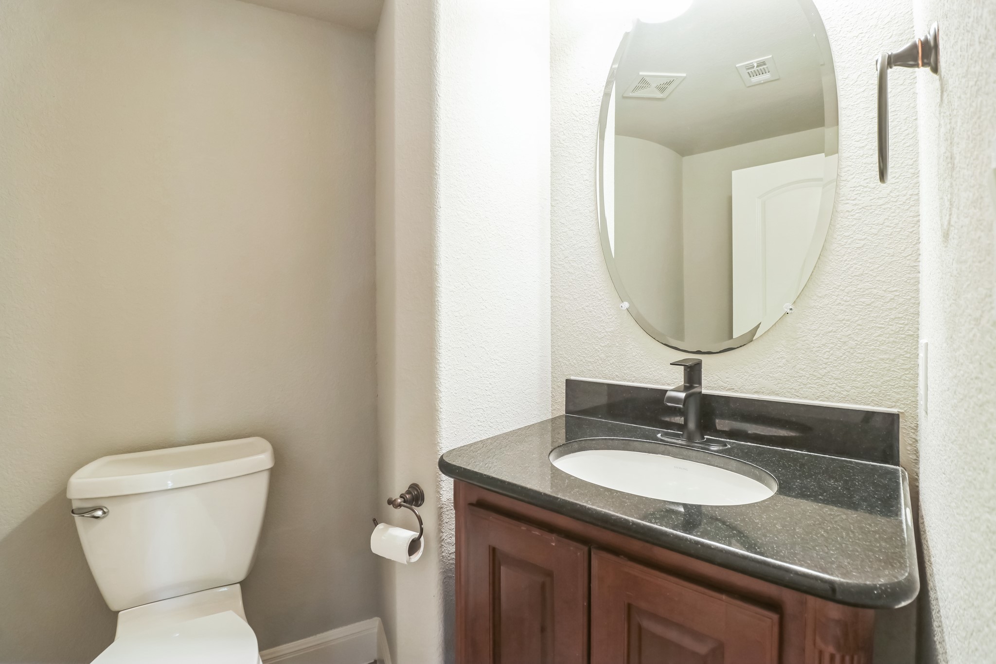 3913 Remington Road Cedar Park, TX 78613 - Photo 16 of 32 A classic vanity featuring dark granite counters and matching dark fixtures highlights this restroom.