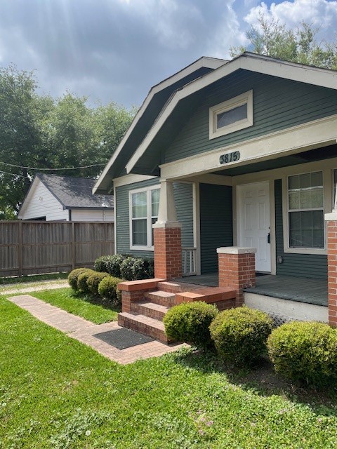 a front view of a house with garden and porch