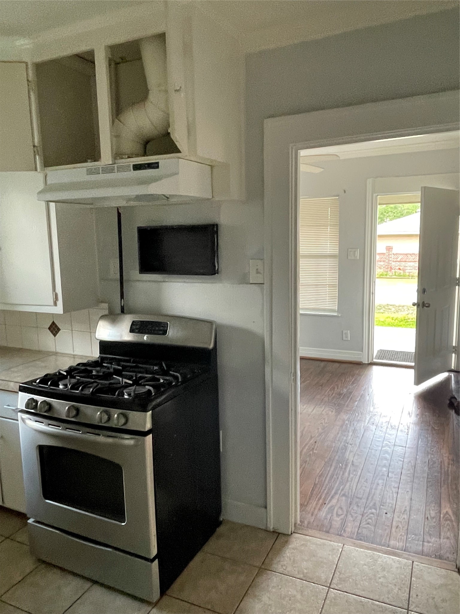 3815 Baden Street Houston, TX 77009 - Photo 3 of 7 a kitchen with a stove and a microwave