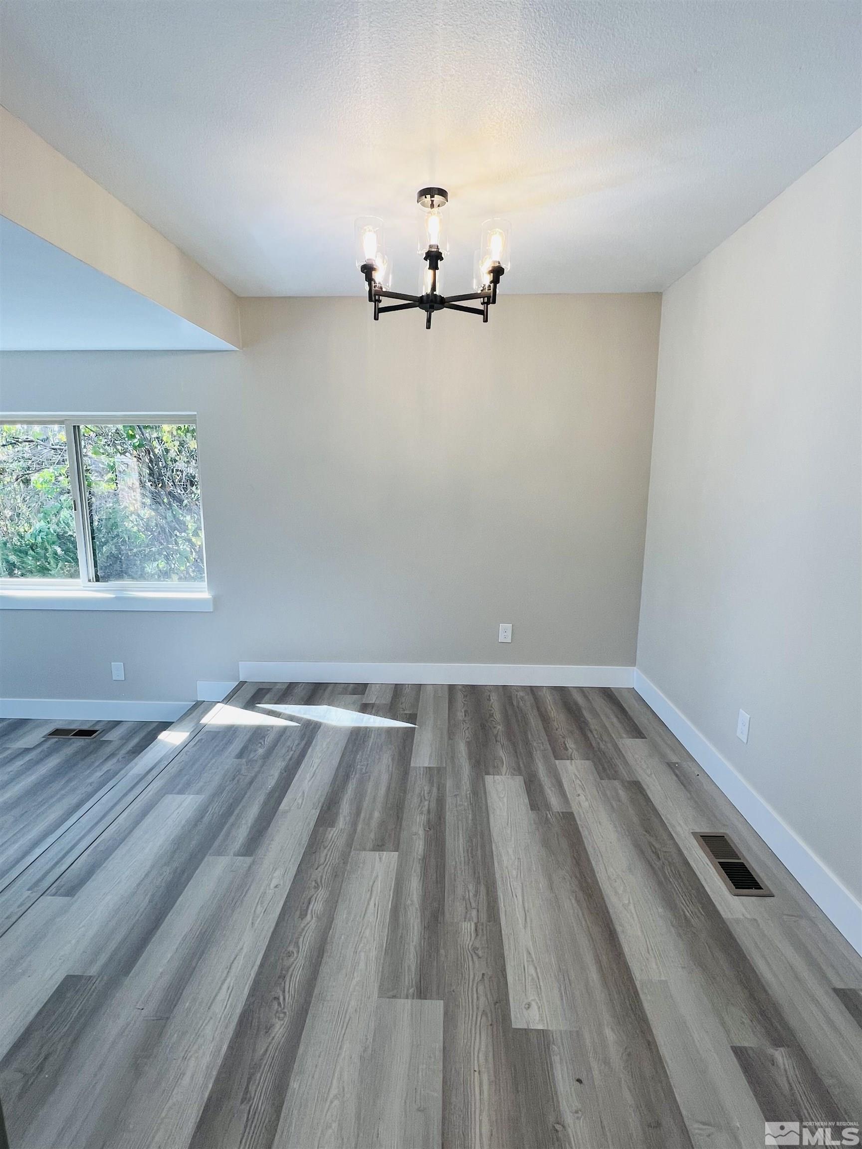 4475 Apollo Drive Carson City, NV 89706 - Photo 18 of 40 wooden floor in an empty room with a window