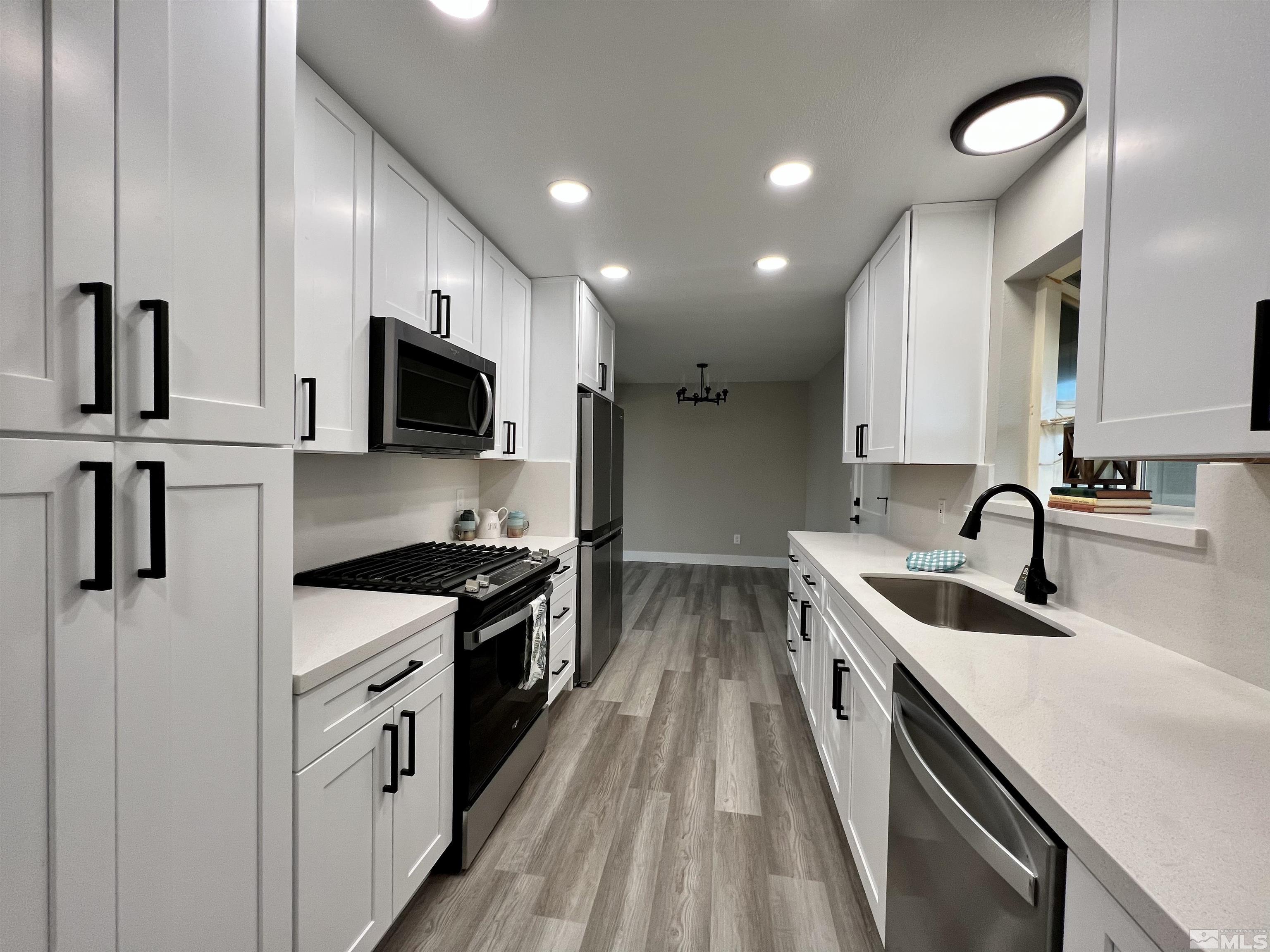 4475 Apollo Drive Carson City, NV 89706 - Photo 2 of 40 a kitchen with stainless steel appliances granite countertop a sink stove and refrigerator
