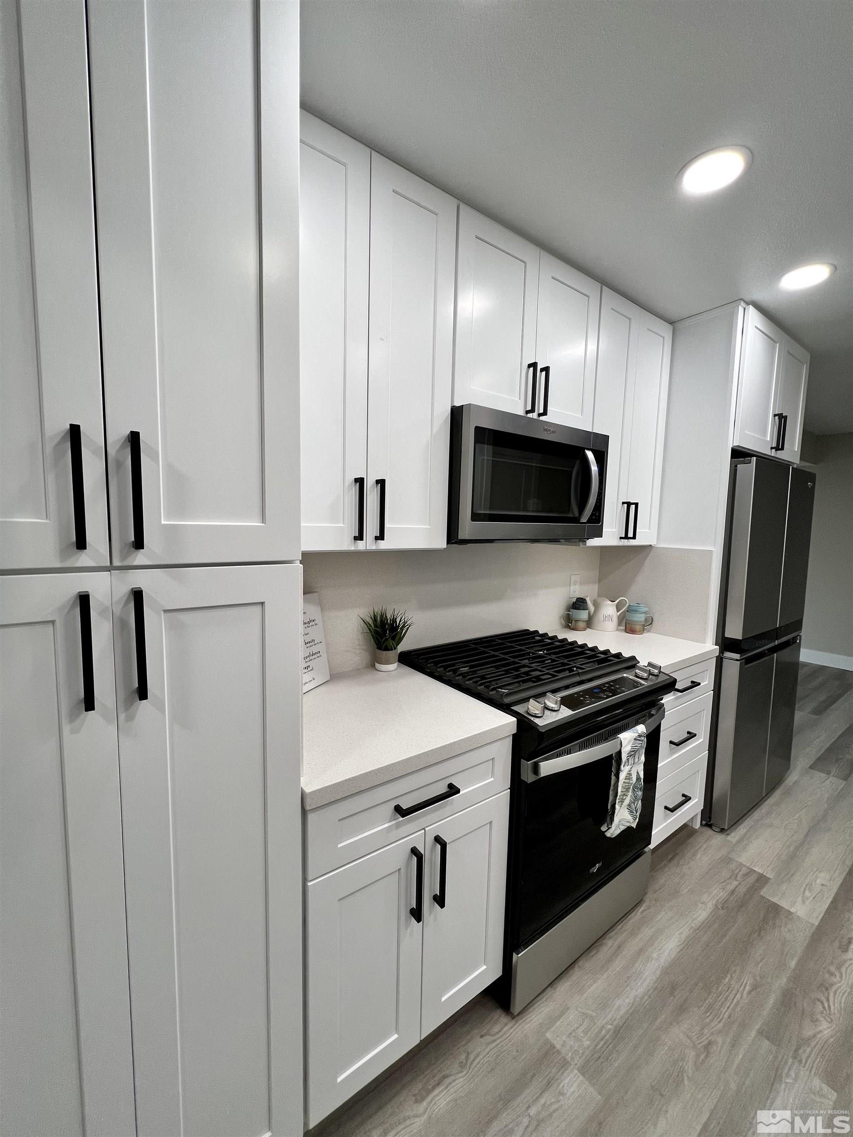 4475 Apollo Drive Carson City, NV 89706 - Photo 29 of 40 a kitchen with white cabinets and stainless steel appliances