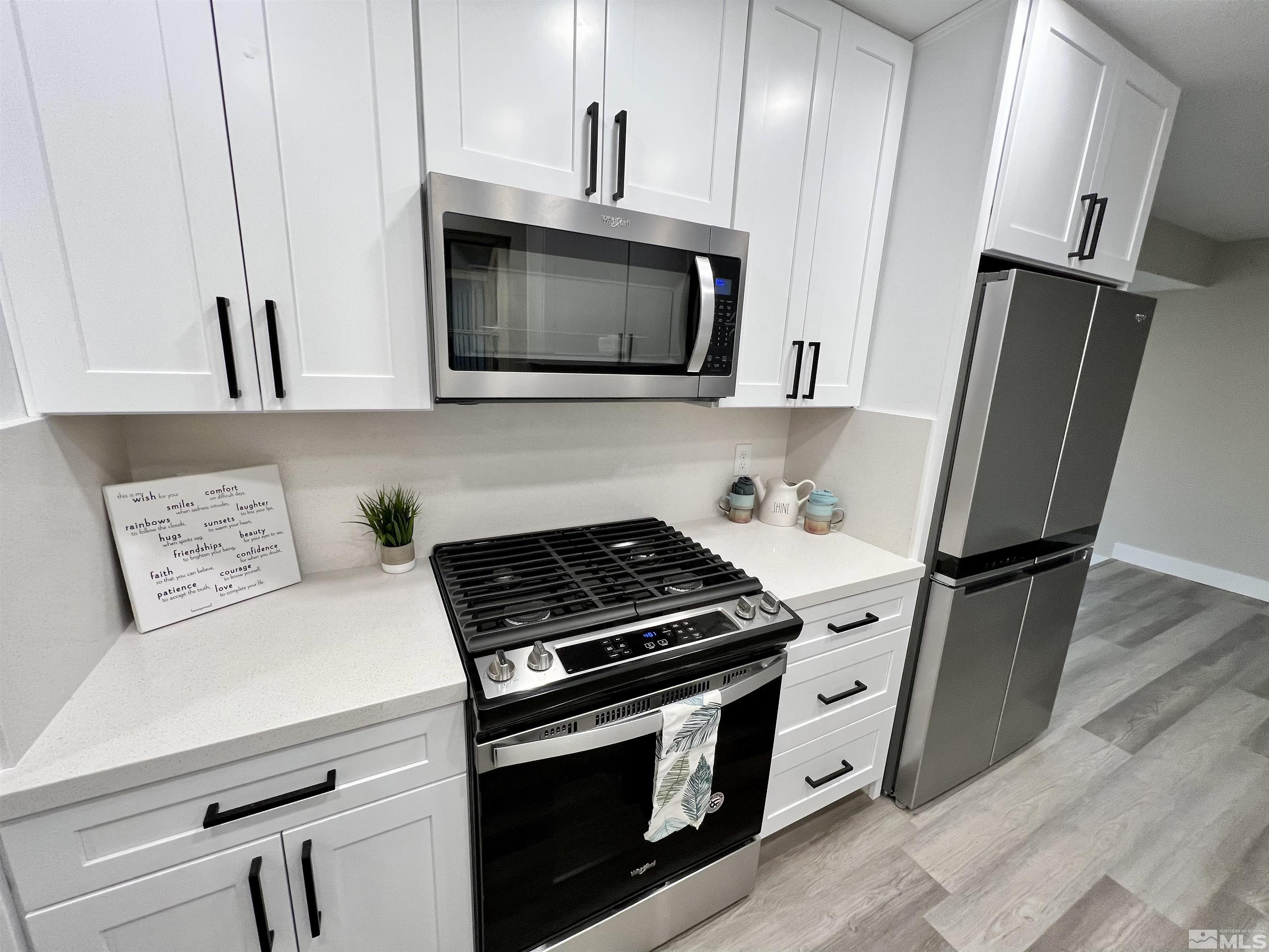 4475 Apollo Drive Carson City, NV 89706 - Photo 30 of 40 a kitchen with stainless steel appliances a stove microwave and sink