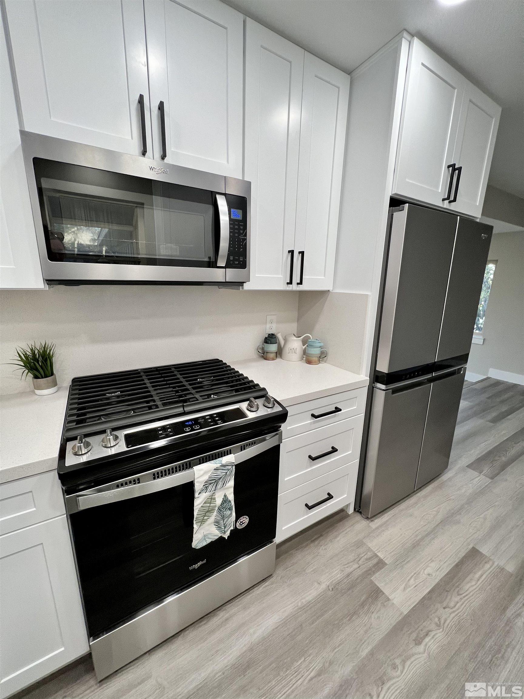 4475 Apollo Drive Carson City, NV 89706 - Photo 31 of 40 a kitchen with white cabinets and stainless steel appliances