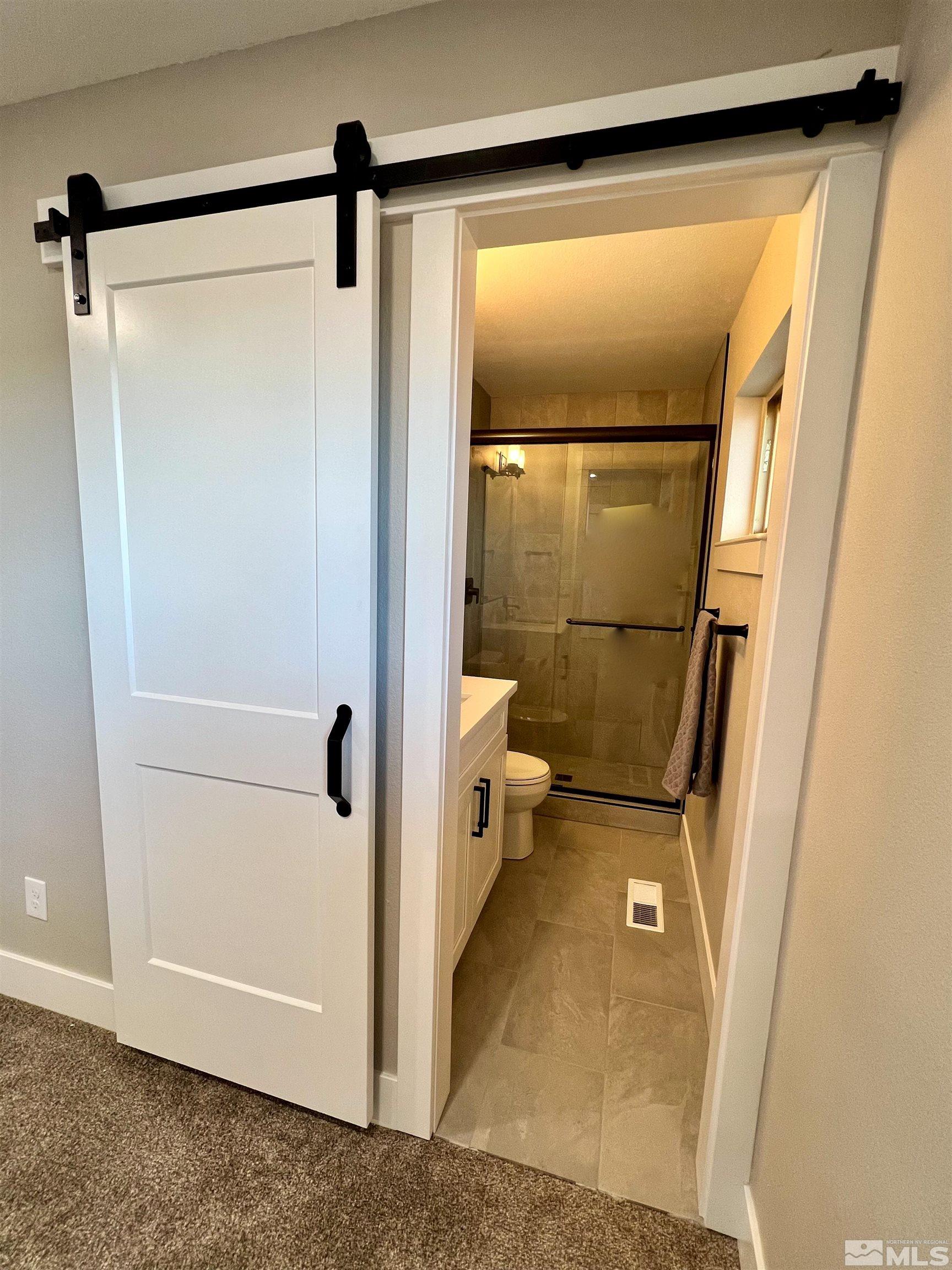 4475 Apollo Drive Carson City, NV 89706 - Photo 38 of 40 a bathroom with a glass shower door