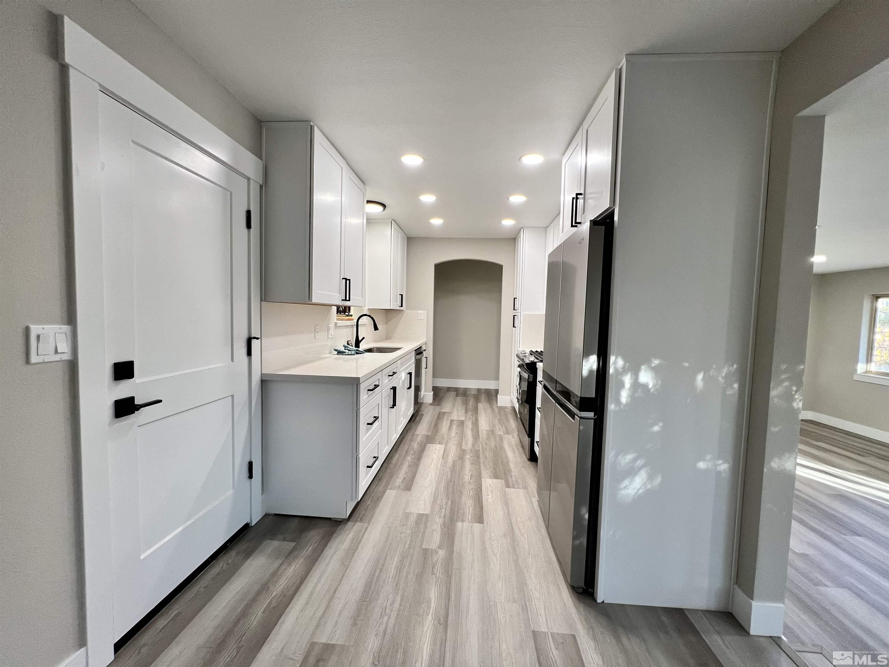 4475 Apollo Drive Carson City, NV 89706 - Photo 4 of 40 a view of a kitchen with a refrigerator and a sink