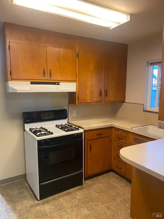 a kitchen with a stove and a sink
