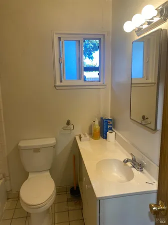 a bathroom with a sink toilet and a mirror