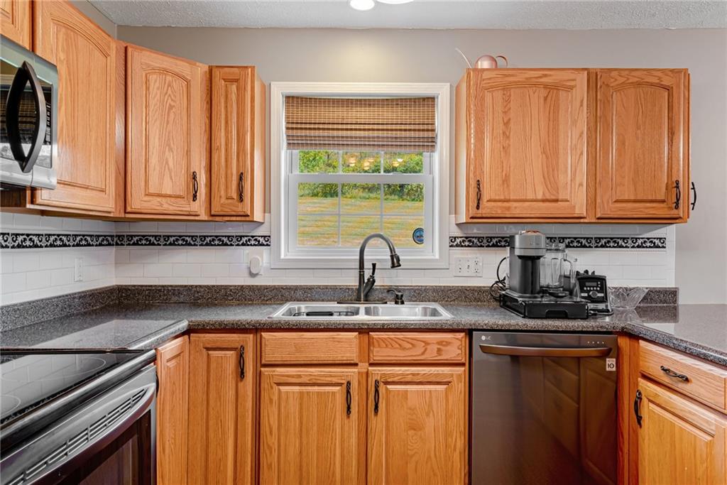 116 Mason Drive Windber, PA 15963 - Photo 11 of 35 a kitchen with granite countertop a sink a stove and cabinets