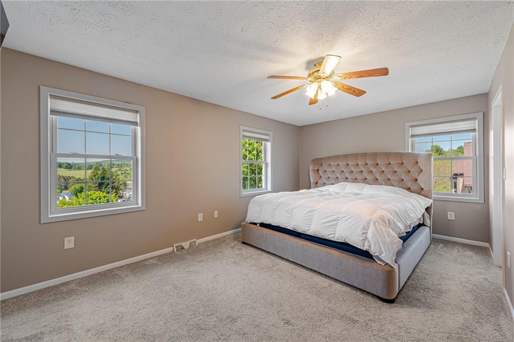 116 Mason Drive Windber, PA 15963 - Photo 19 of 35 a spacious bedroom with a bed and a chandelier