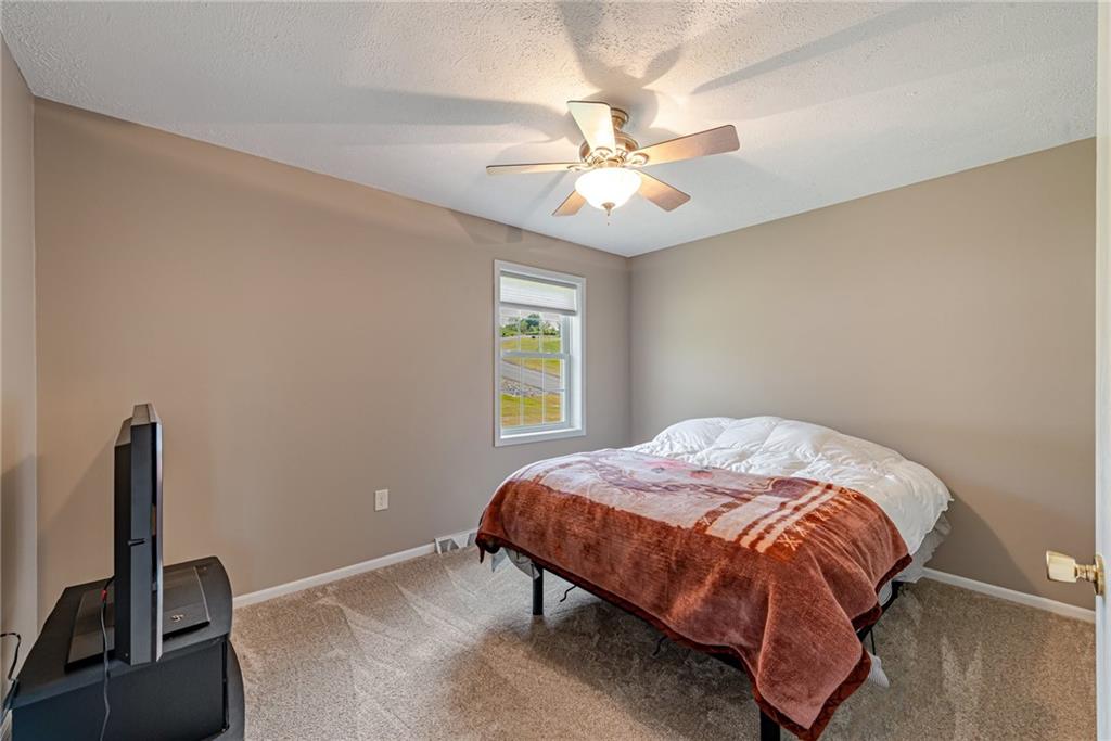 116 Mason Drive Windber, PA 15963 - Photo 25 of 35 a bedroom with a bed and a chandelier