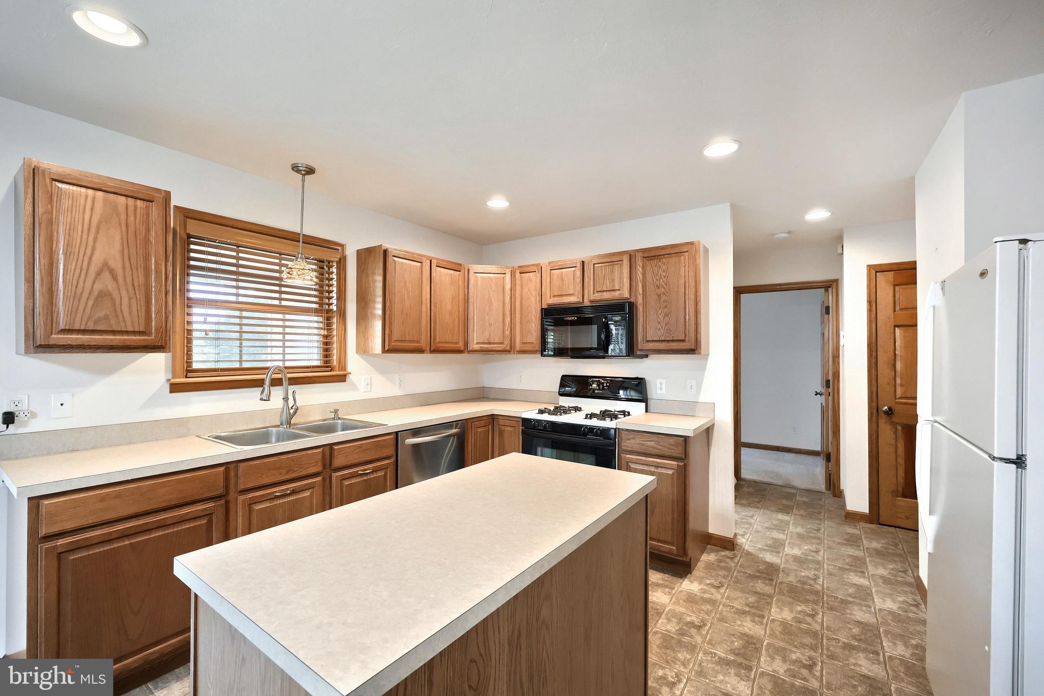 965 East Butter Road York, PA 17406 - Photo 25 of 54 a kitchen with stainless steel appliances a stove sink refrigerator and cabinets