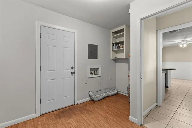 a view of empty room with wooden floor