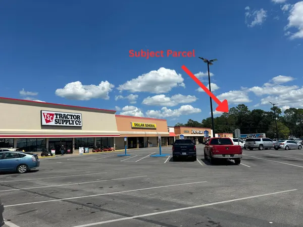 a view of a building with car parked