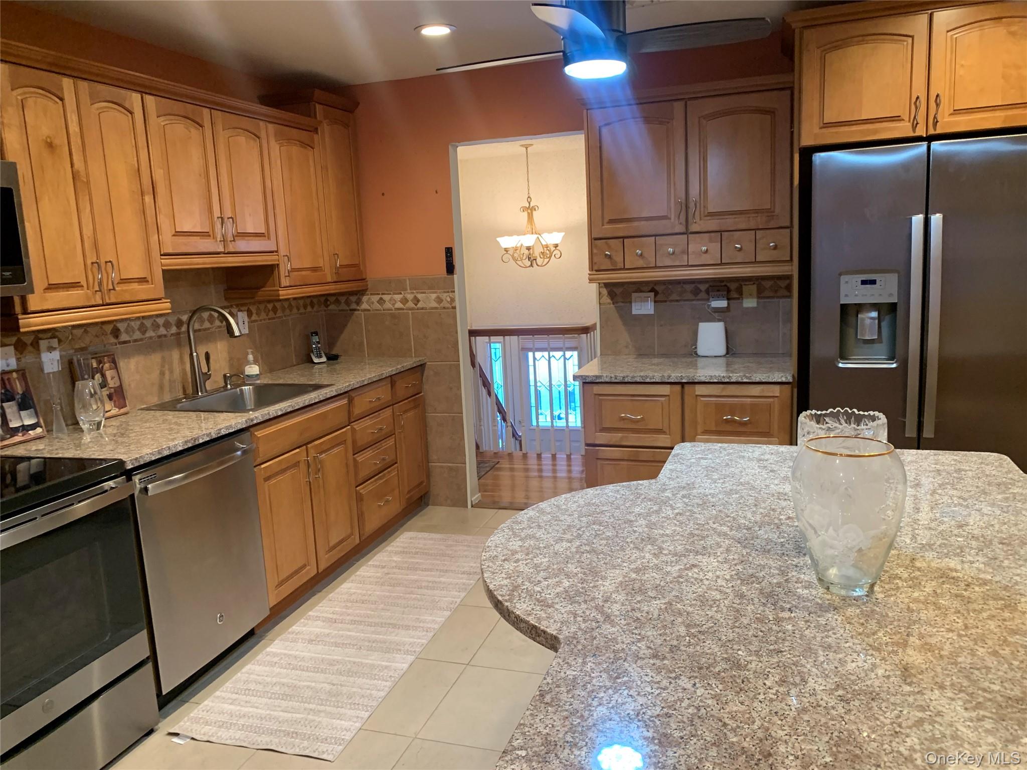 8 Autumn Lane Stony Point, NY 10980 - Photo 5 of 40 a kitchen with stainless steel appliances granite countertop a sink refrigerator and cabinets