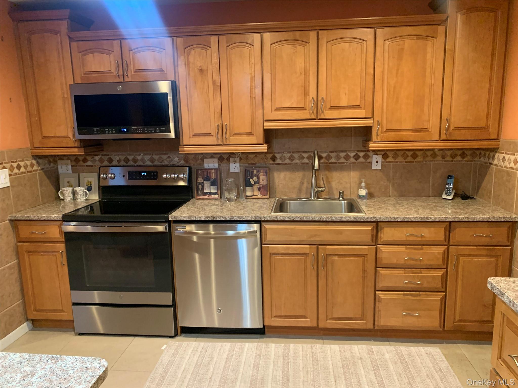 8 Autumn Lane Stony Point, NY 10980 - Photo 6 of 40 a kitchen with stainless steel appliances granite countertop a stove a sink and a microwave