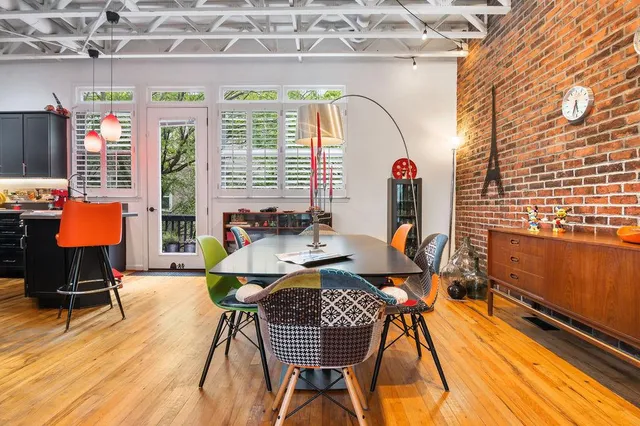 a kitchen with kitchen island stainless steel appliances a sink and a table