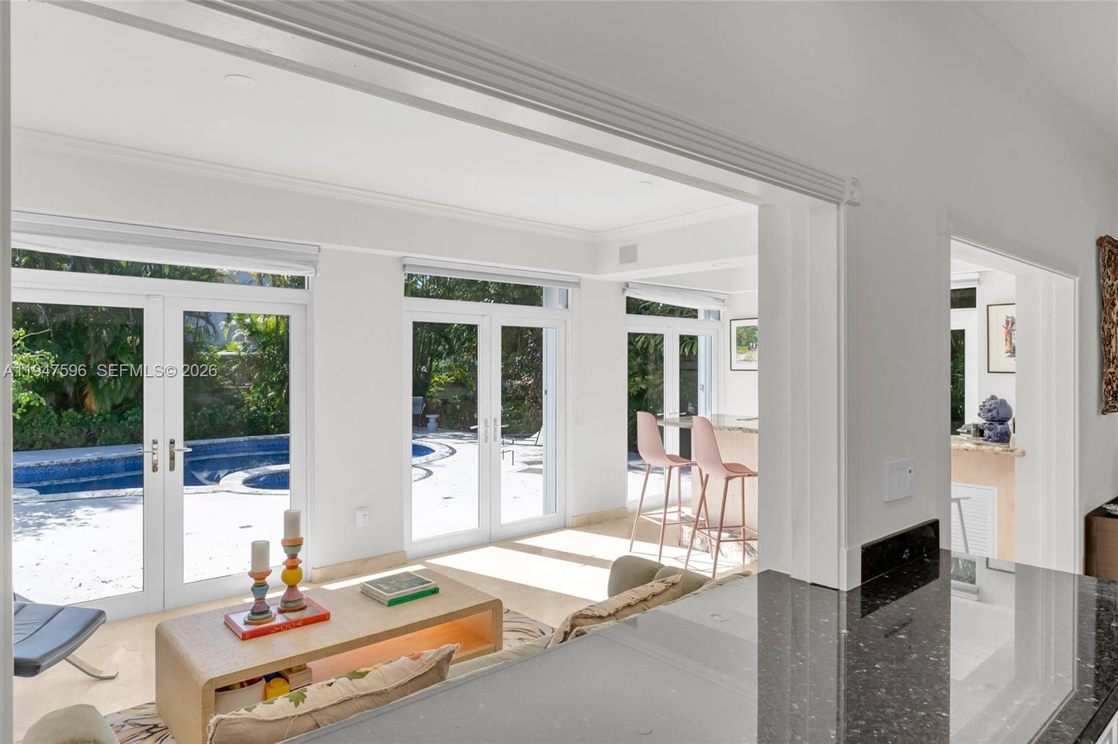 5794 Southwest 76th Terrace South Miami, FL 33143 - Photo 13 of 28 a living room with patio furniture and floor to ceiling windows