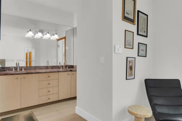 a bathroom with a granite countertop toilet sink and mirror
