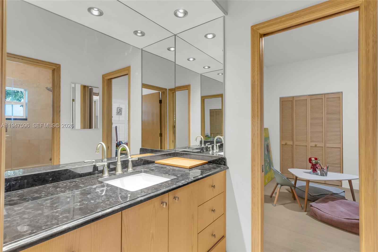 5794 Southwest 76th Terrace South Miami, FL 33143 - Photo 22 of 28 a bathroom with a granite countertop sink and a mirror