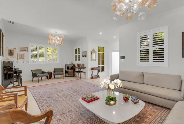 a living room with furniture chandelier and window