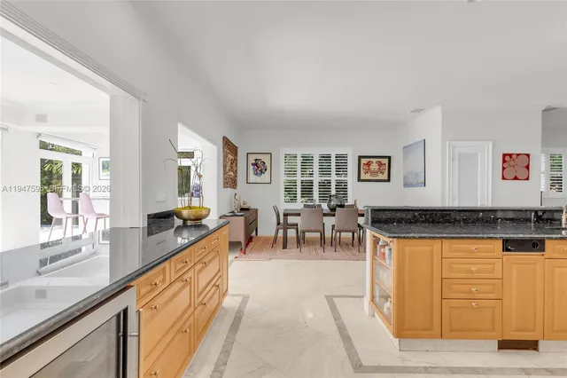 a living room with furniture a dining table and chairs with wooden floor