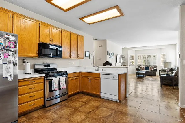 a kitchen with stainless steel appliances granite countertop a stove sink and cabinets