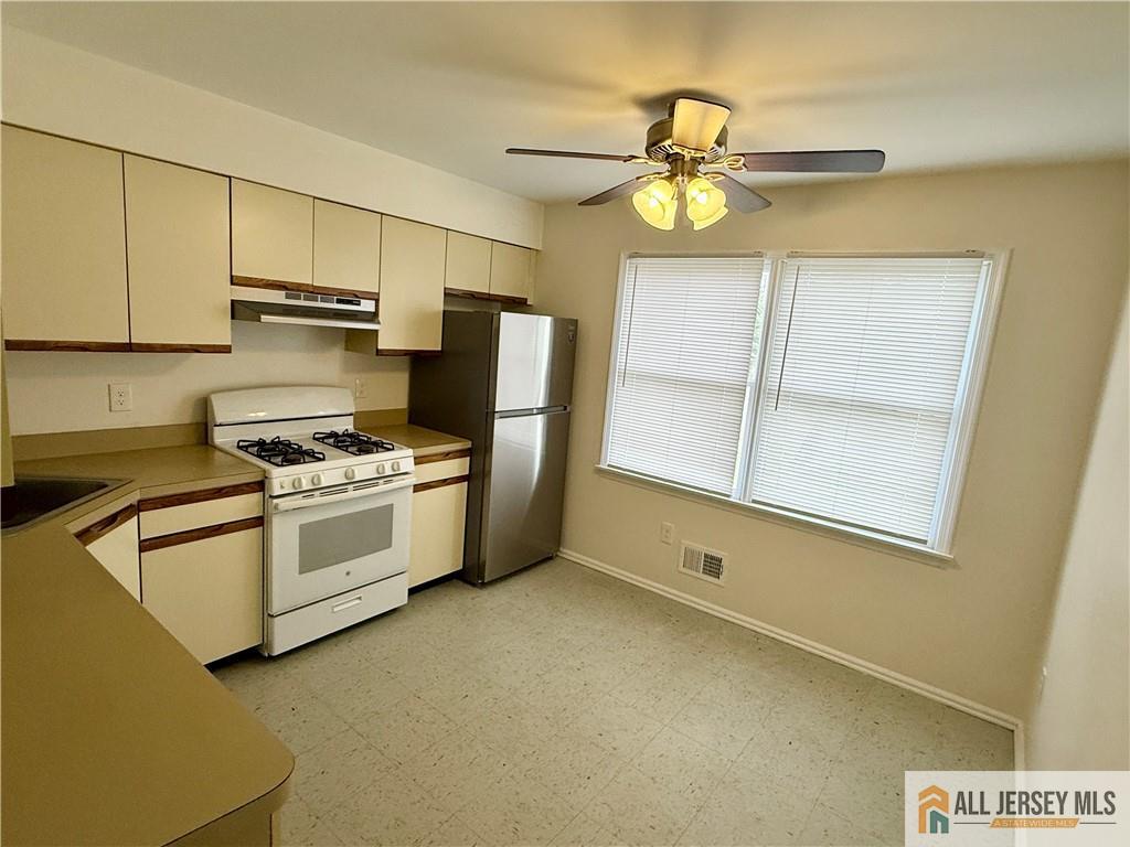 285 South Lincoln Avenue Middlesex, NJ 08846 - Photo 4 of 11 a kitchen with white cabinets and white appliances
