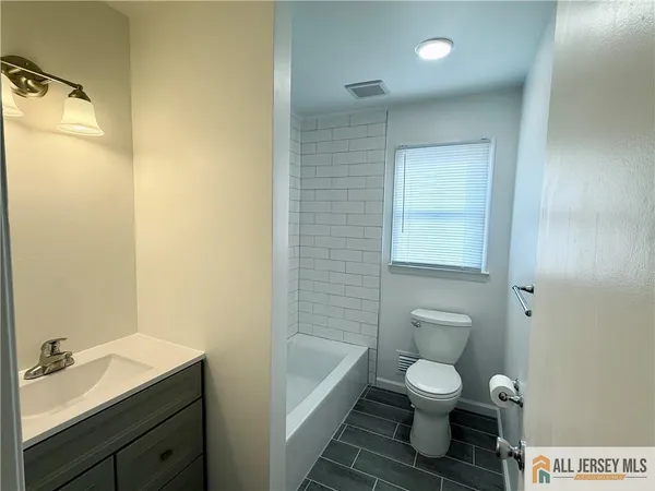 a bathroom with a toilet a sink and bathtub