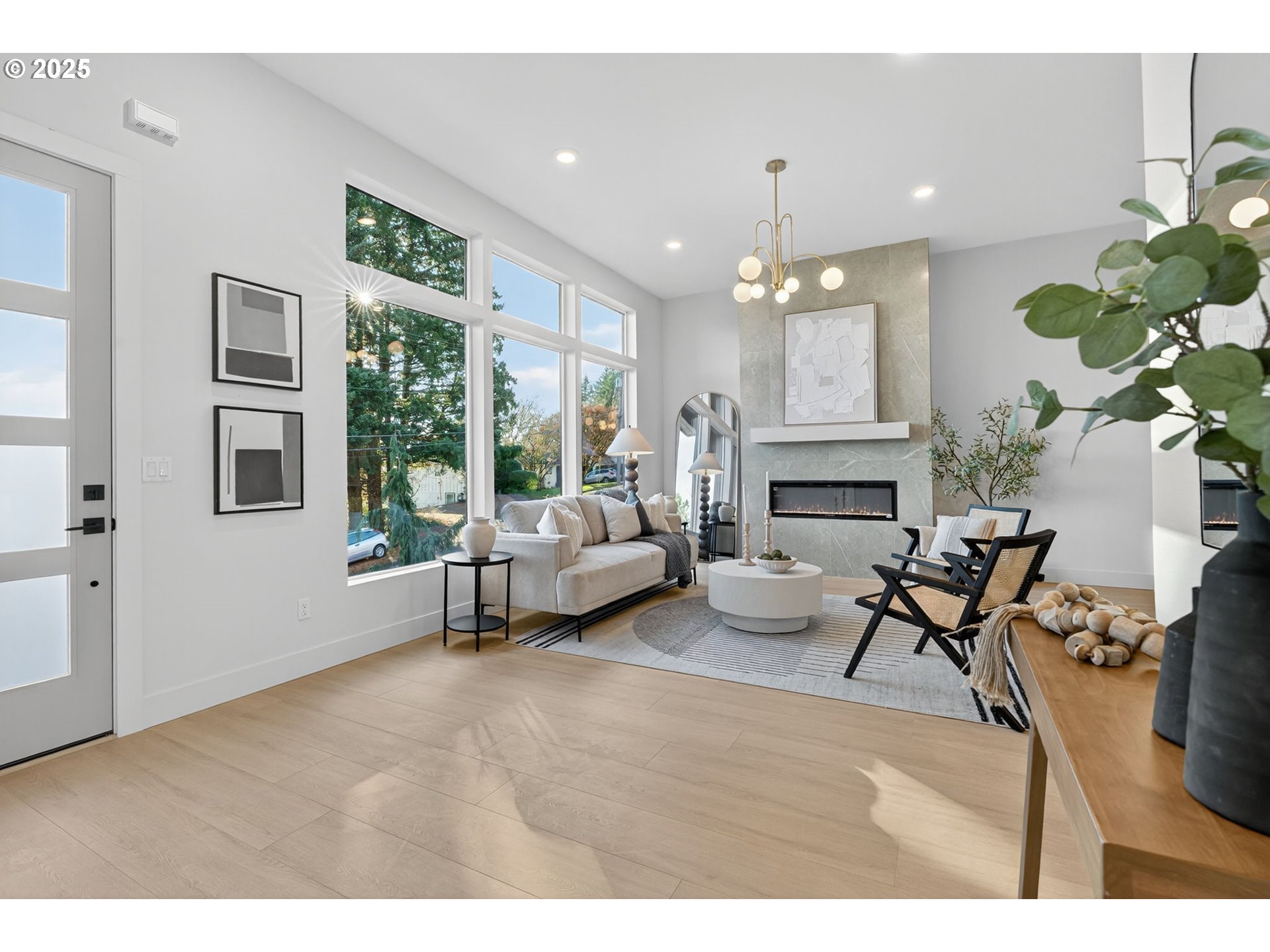 1501 Northwest 8th Avenue Camas, WA 98607 - Photo 5 of 47 a living room with furniture a fireplace and a chandelier