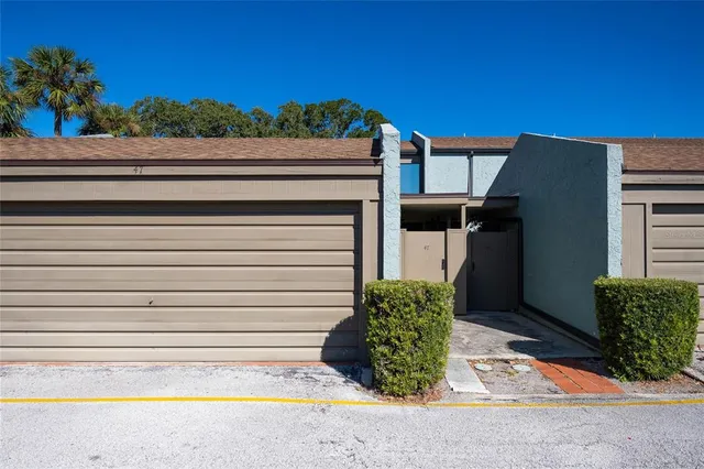 a view of backyard with tub and potted plants