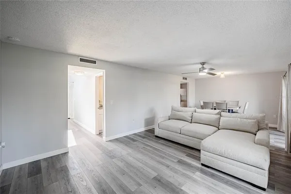 a living room with furniture and wooden floor