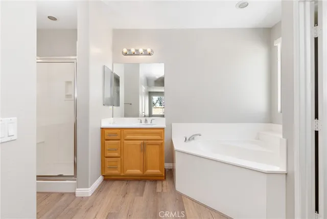 a bathroom with a granite countertop sink a mirror and a shower