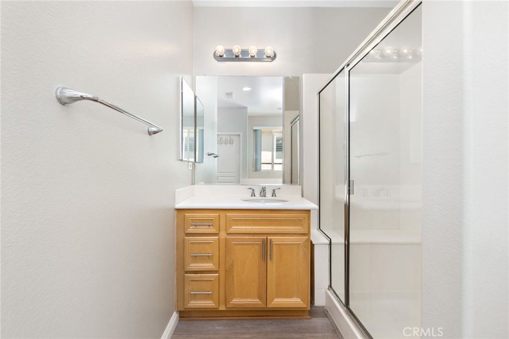 1580 Turtle Creek Beaumont, CA 92223 - Photo 14 of 39 a bathroom with a granite countertop sink a mirror and a shower