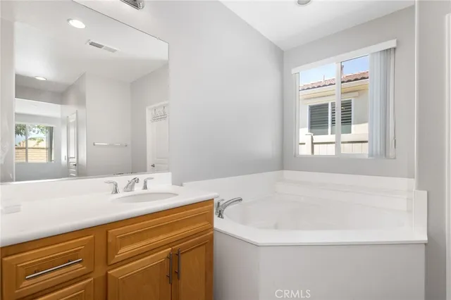 a white bath tub sitting next to a white toilet