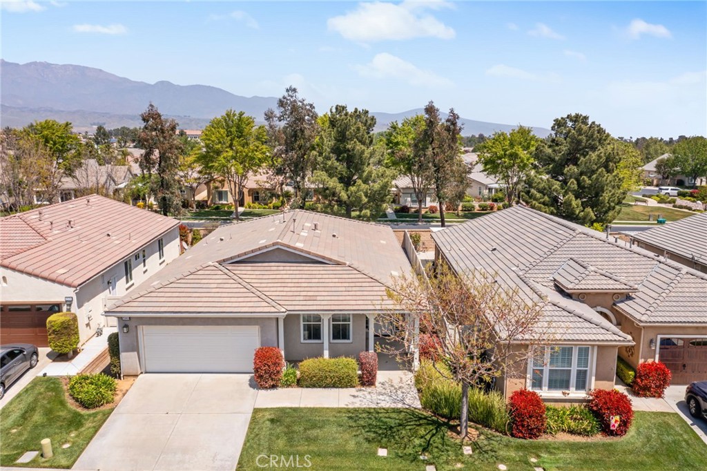 1580 Turtle Creek Beaumont, CA 92223 - Photo 30 of 39 a front view of a residential houses with yard and mountain view in back